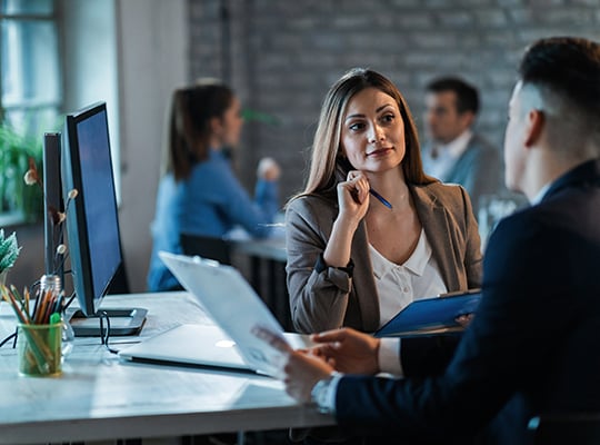 business woman at desk with client