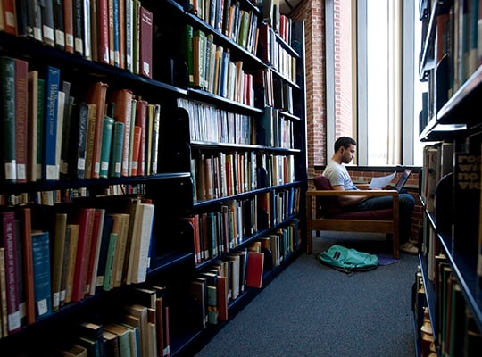 student in library