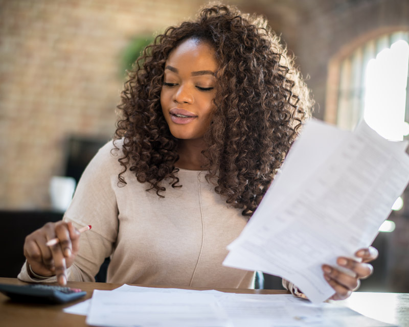 woman at desk with calculator