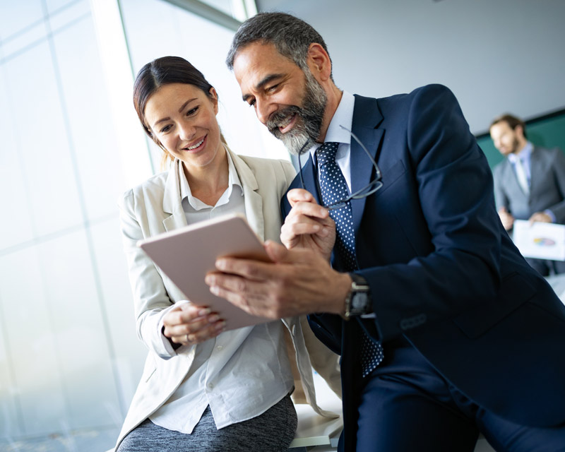 business manager sharing tablet with information